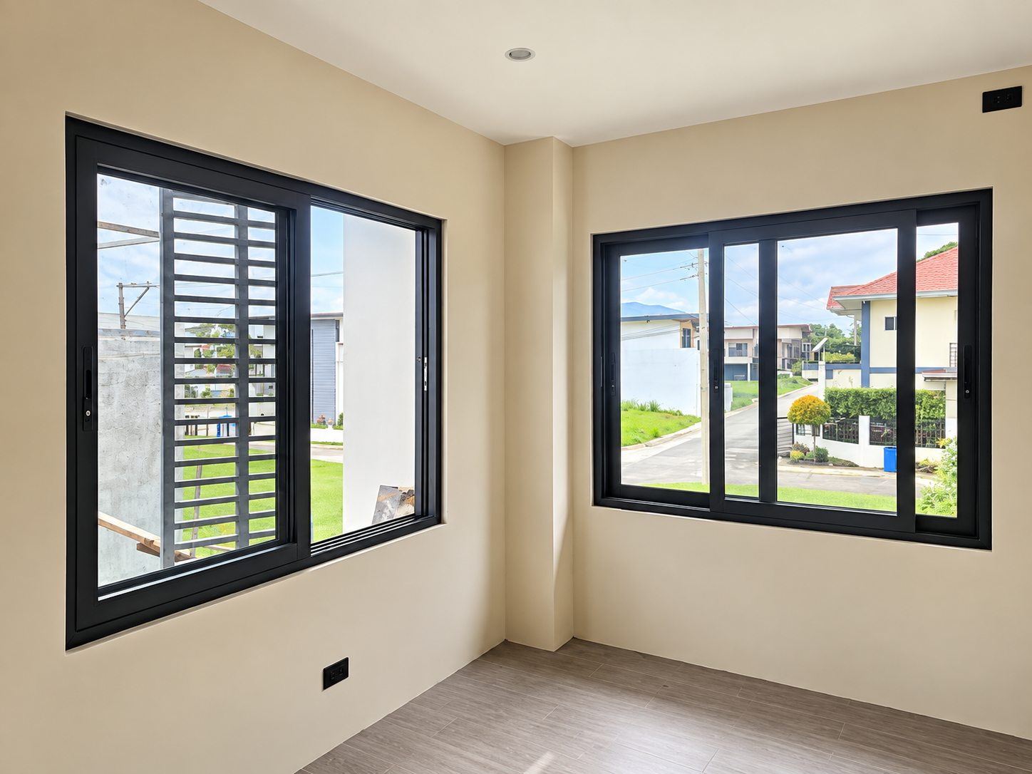 OTEC Window Installation Update in Lipa, Batangas Dark aluminium sliding windows viewed from inside a residential room.
