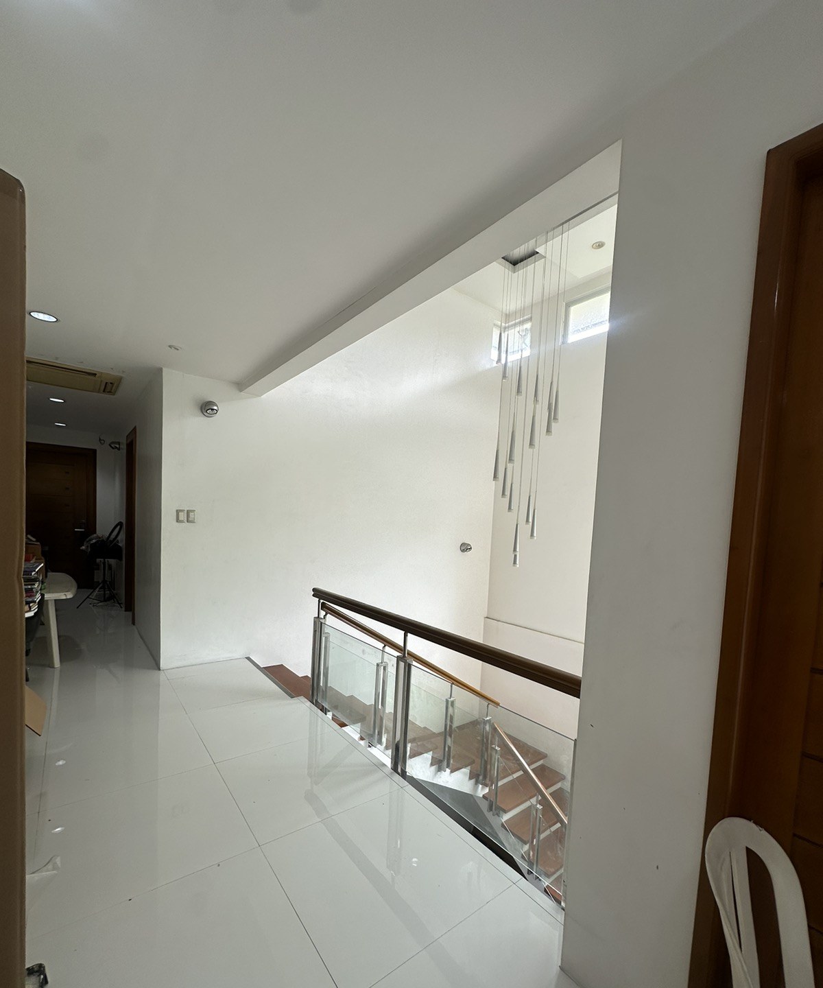 A finished glass stair railing with a timber handrail in a private residence.