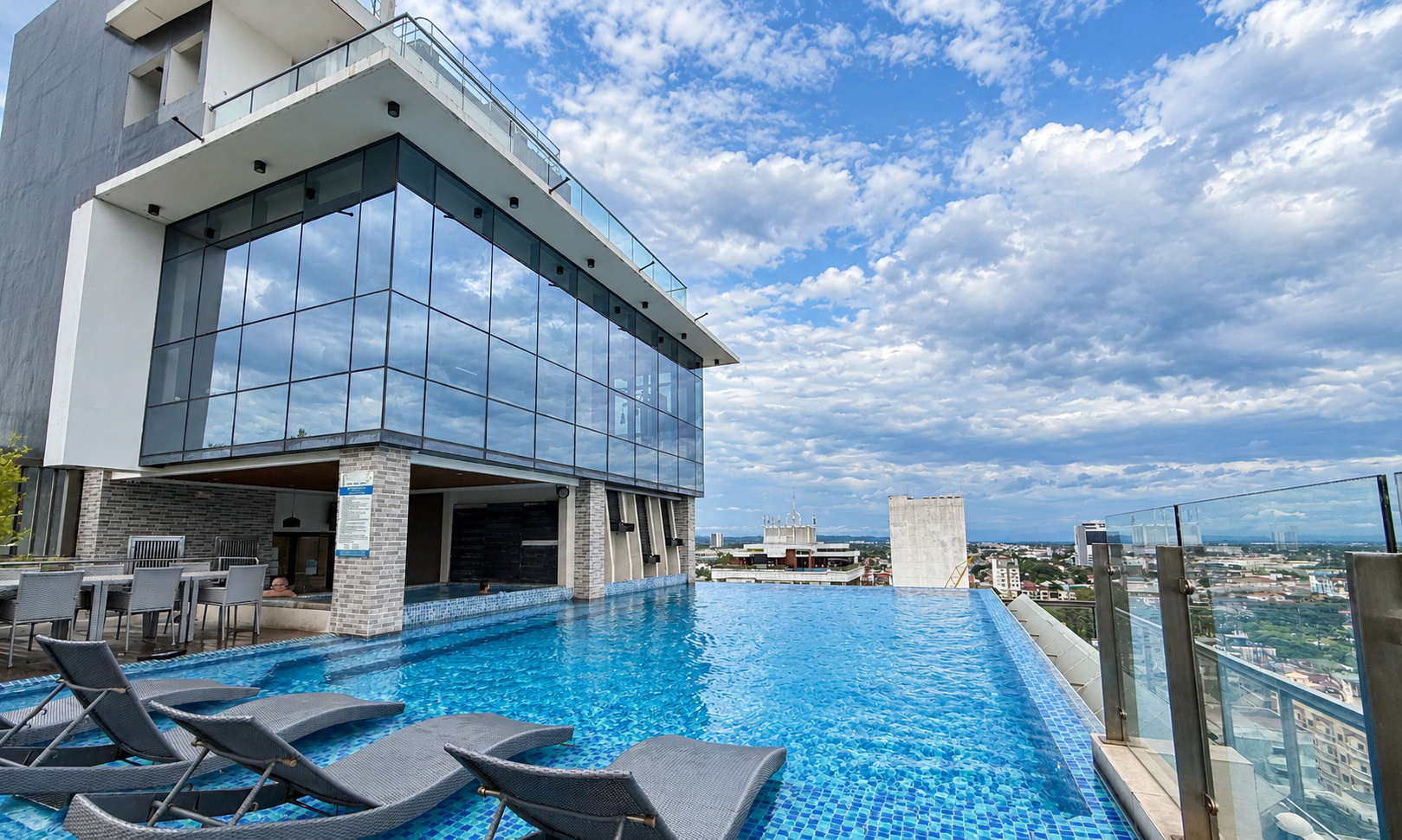 One Euphoria rooftop amenity area featuring glass railings