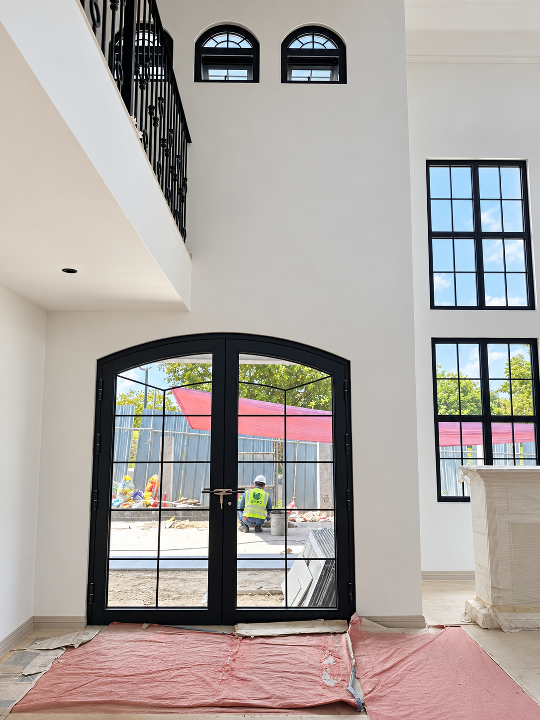Large arched black aluminum glass door at Laguna residence